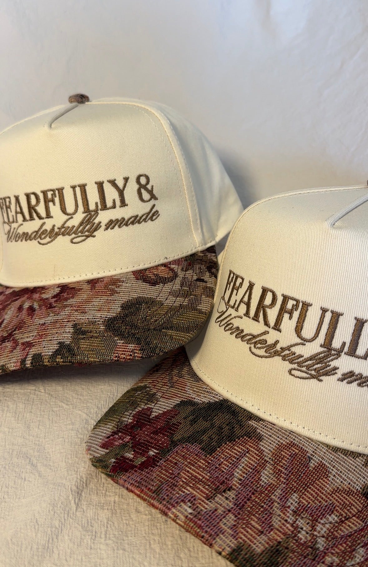 Fearfully and Wonderfully Made floral trucker hat with faith-inspired design